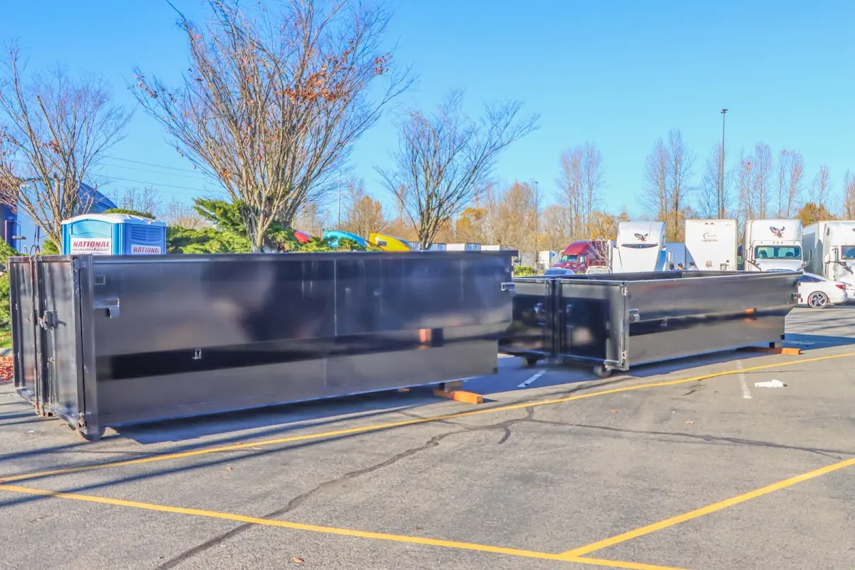 Professional dumpster rental service with roll-off container on residential driveway in Romeoville